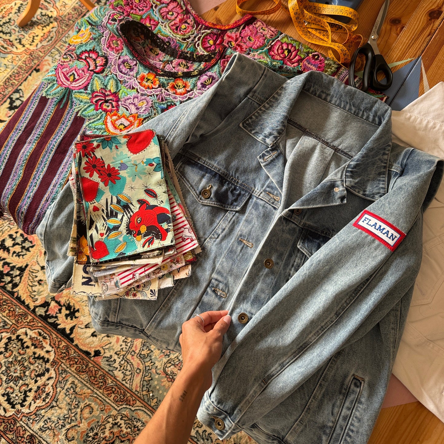 Denim jacket with a brand label on a patterned surface