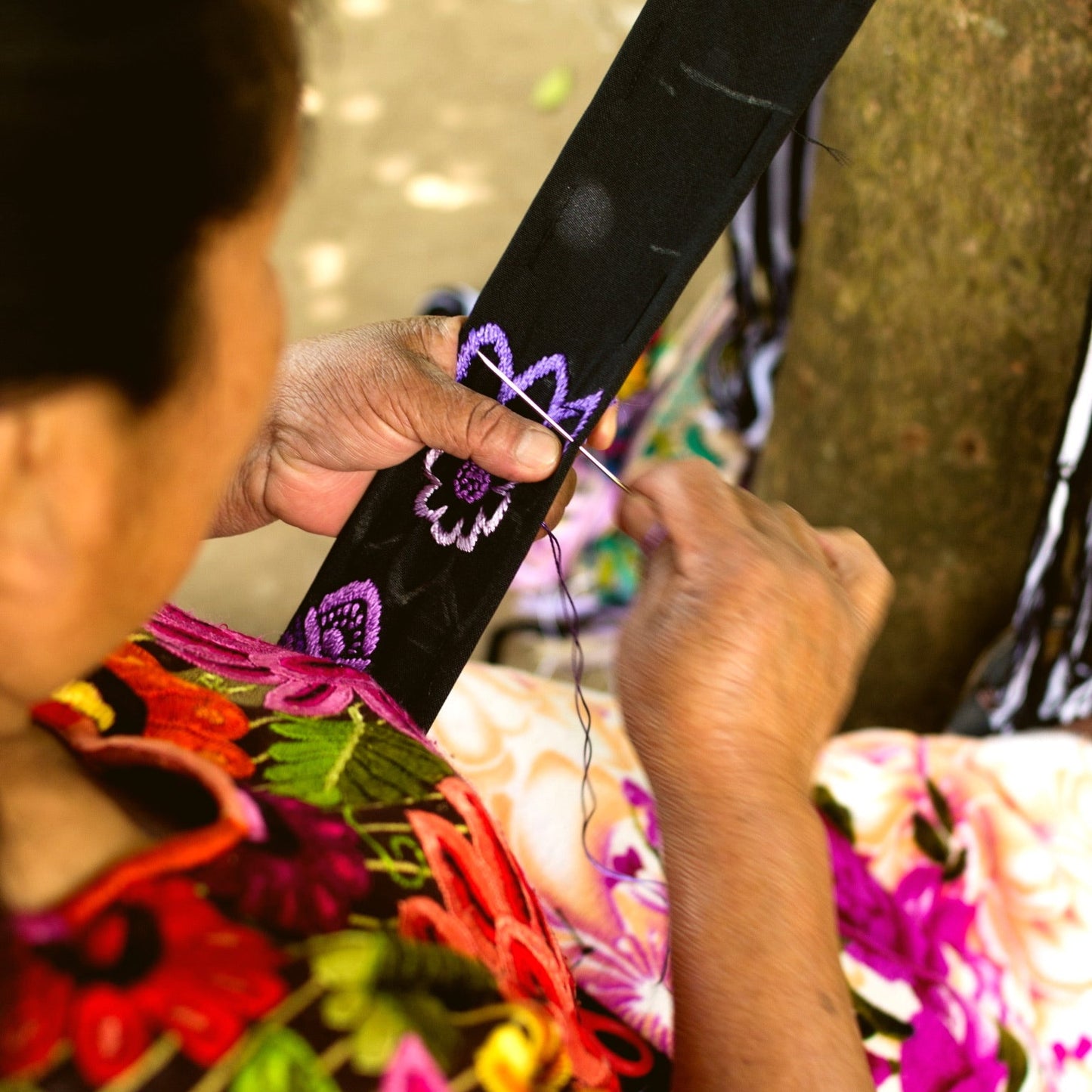 Person holding a colorful kite with floral patterns