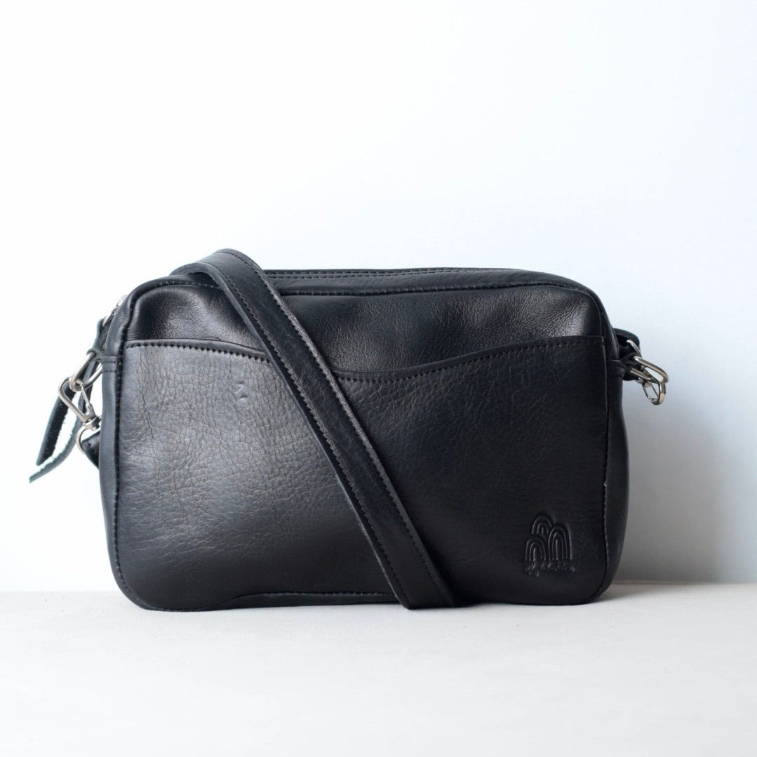 Black leather crossbody bag on a white background