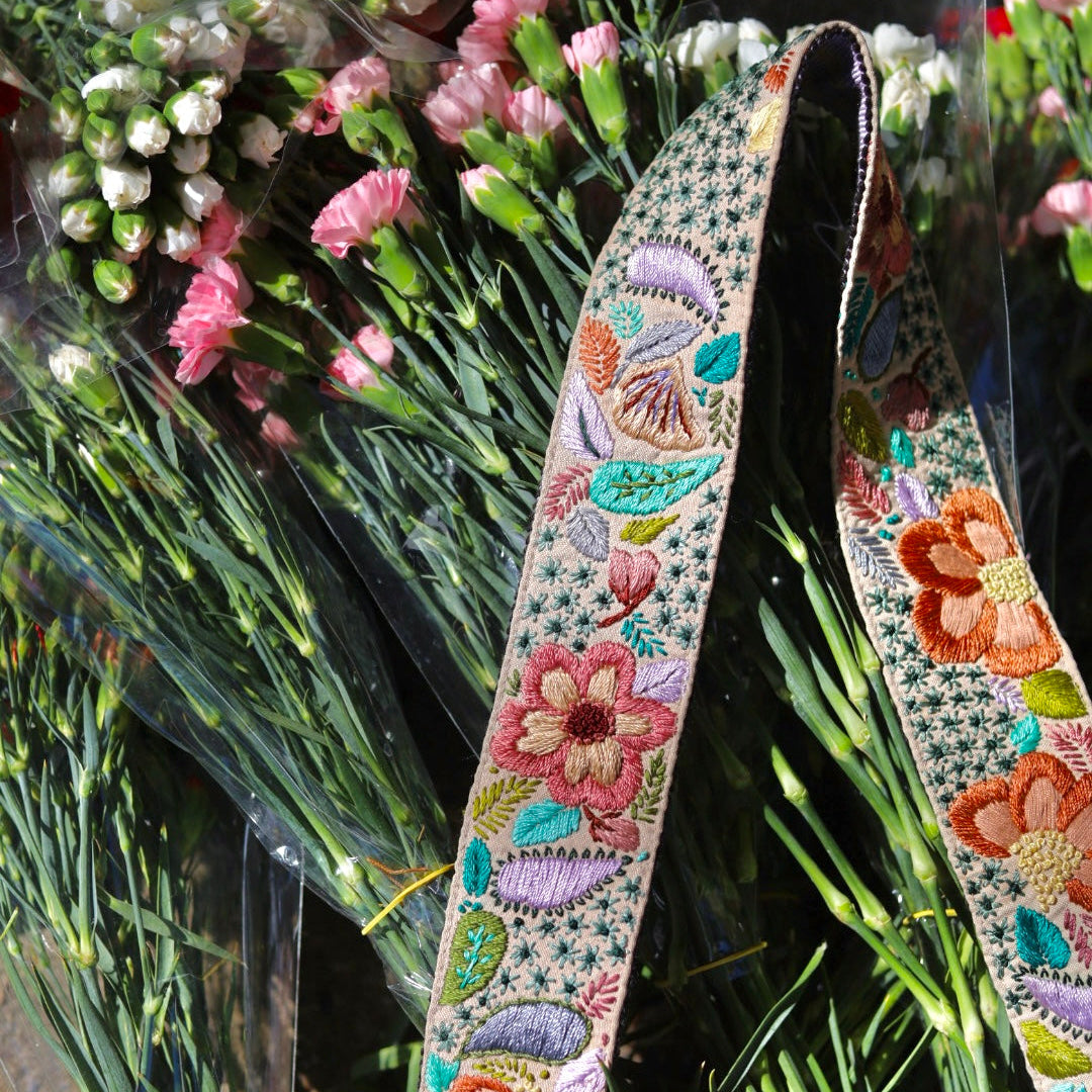 Decorative floral ribbon with a bouquet of flowers in the background