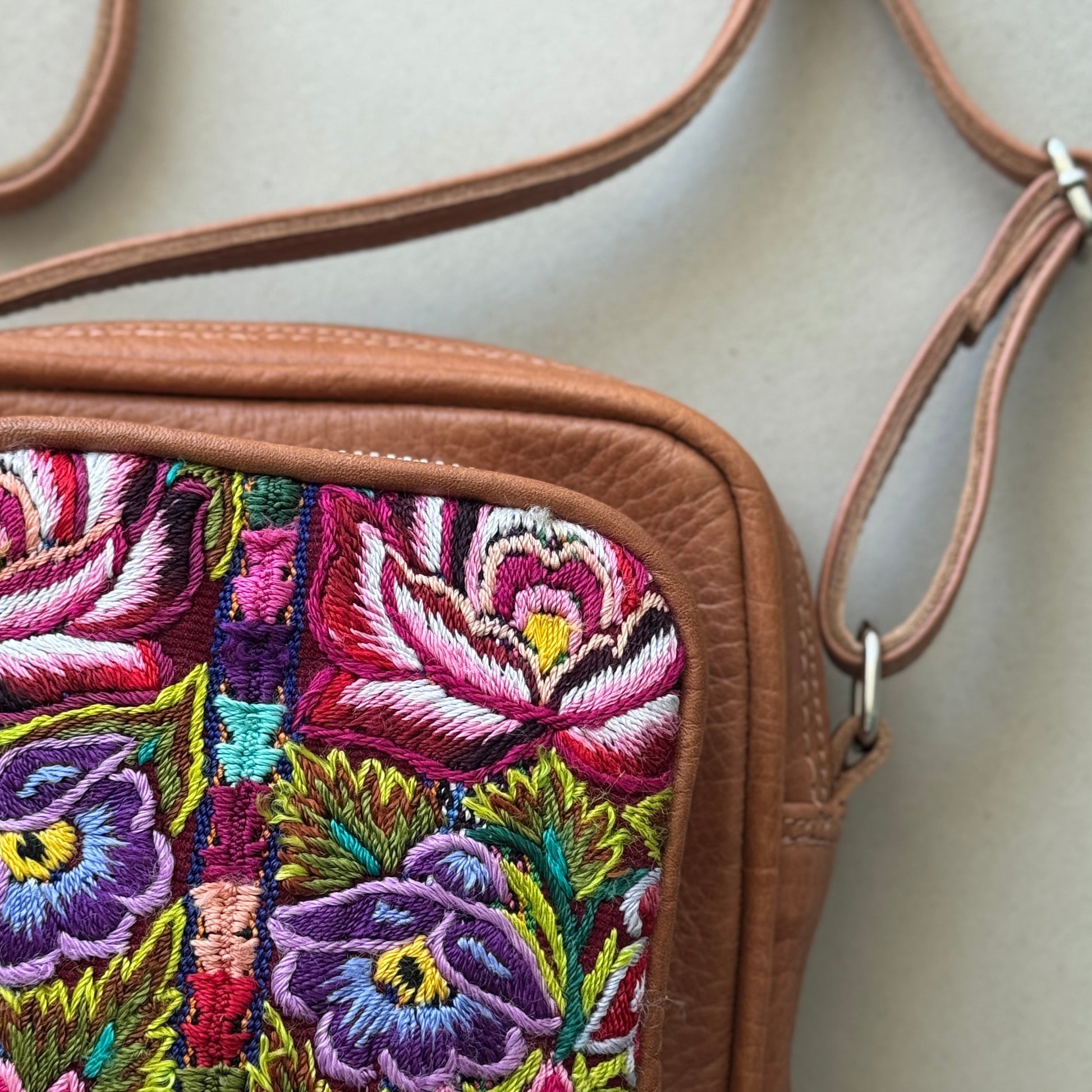 Floral embroidered bag with a beige background
