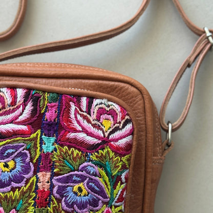 Floral embroidered bag with a beige background