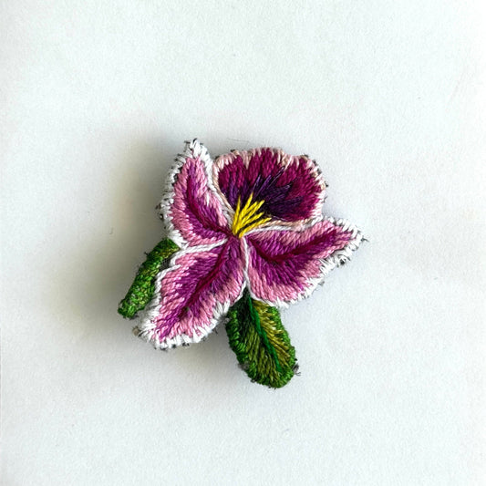 Floral embroidered patch on a white background