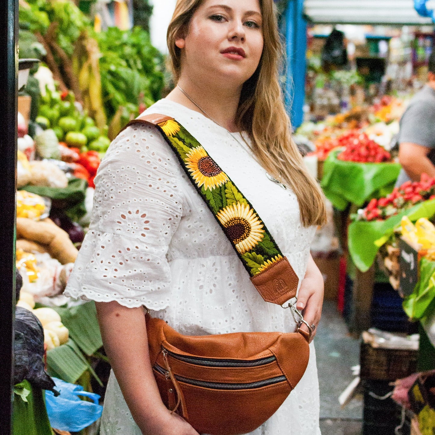 Woman with a sunflower-patterned bag in a market setting