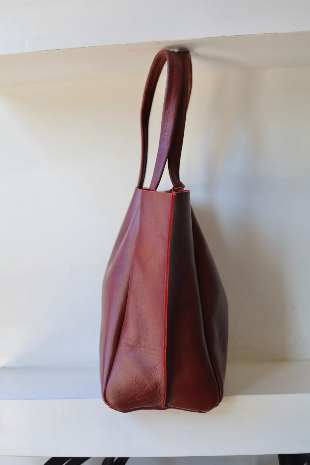 Brown leather handbag on a white background