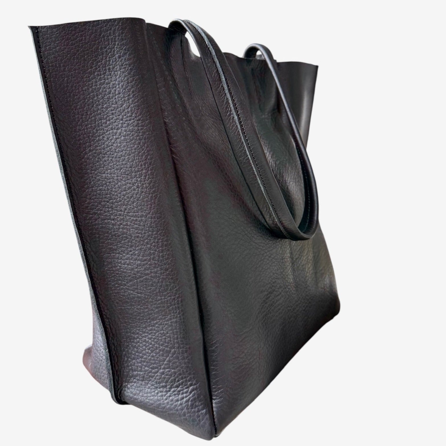 Black leather tote bag on a white background