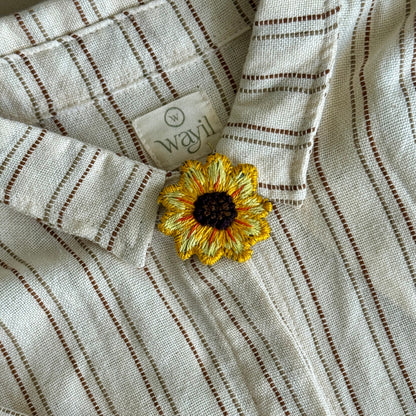 Striped fabric with a sunflower decoration and a visible brand label.