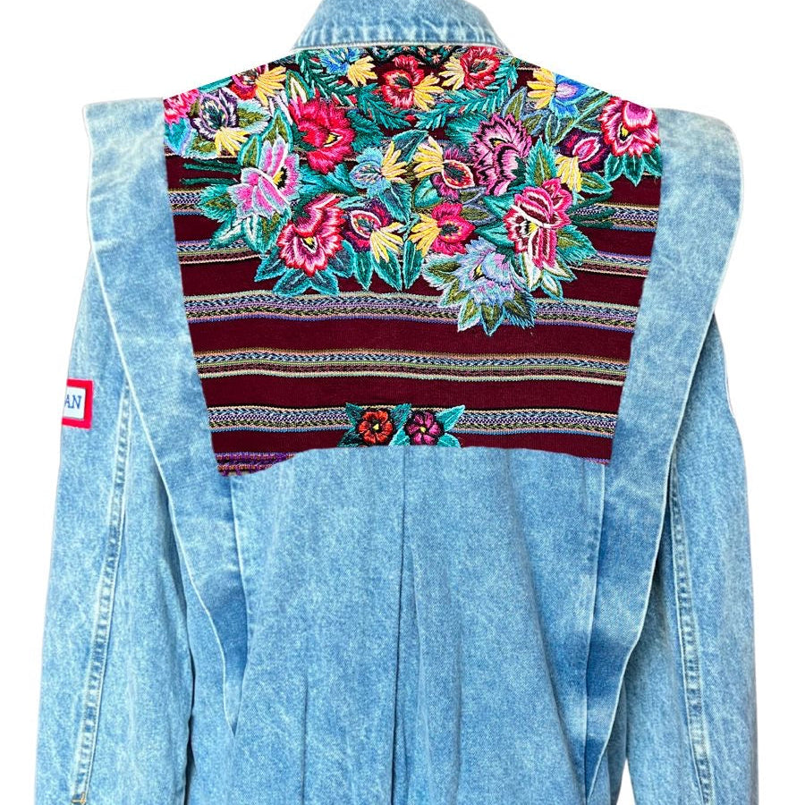 Light blue denim jacket with colorful floral embroidery on a white background