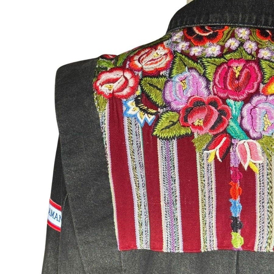 Gray denim jacket with colorful floral embroidery on a white background