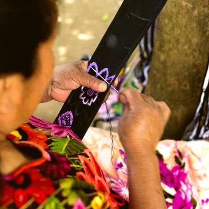 Person holding a colorful kite with floral patterns