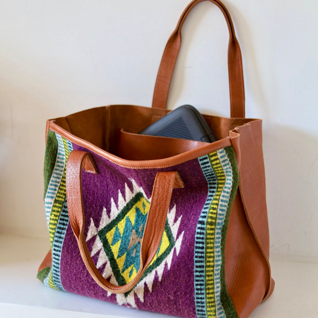 Brown tote bag with colorful pattern on a white surface